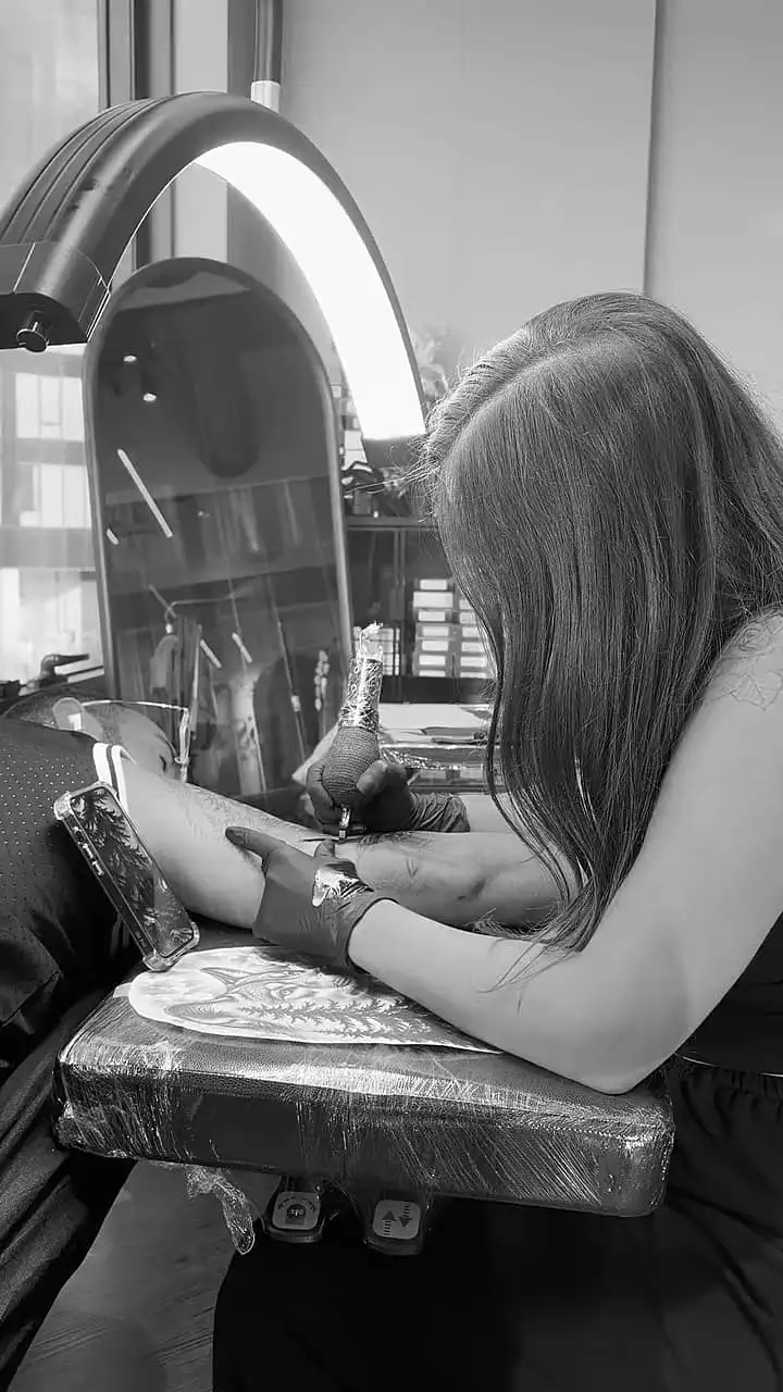 Black and white clips from Eden Zohar's studio: drawing a design, laying a stencil and tattooing.