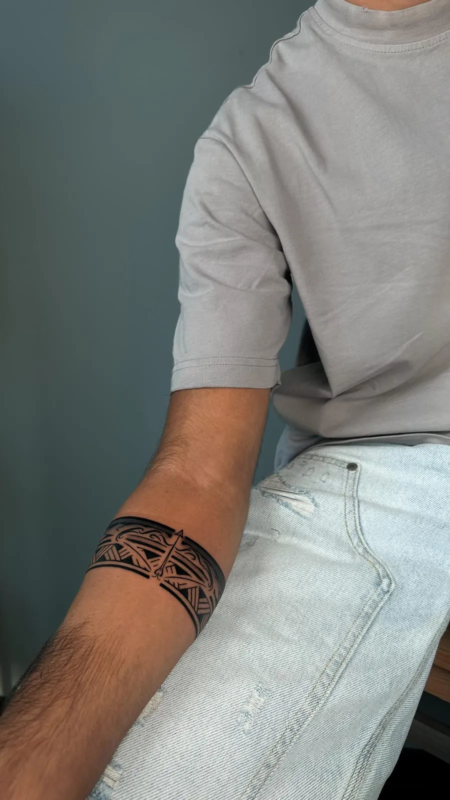 Black ornamental band around the forearm.